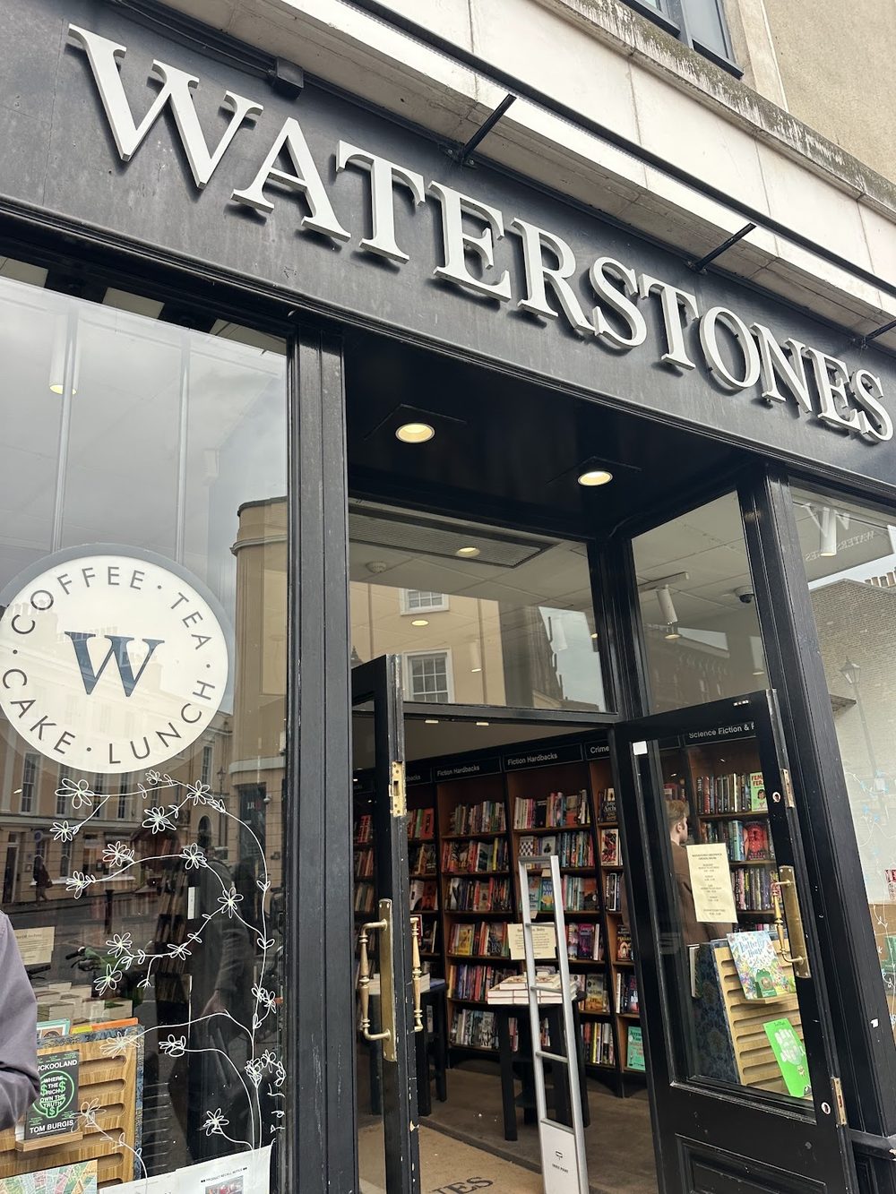 The café entrance on Greenwich Church Street, with its round W sign outside the bookshop